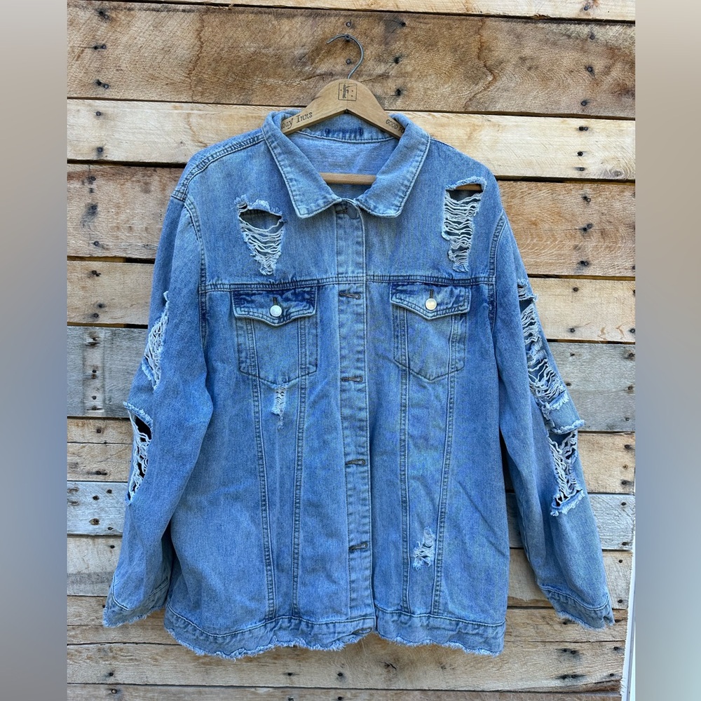 Ripped Jean jacket. The tag is gone in which I forget the brand.